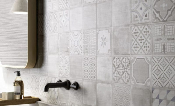 Matte Black Faucet Against Patterned Tiles (Marazzi Group)